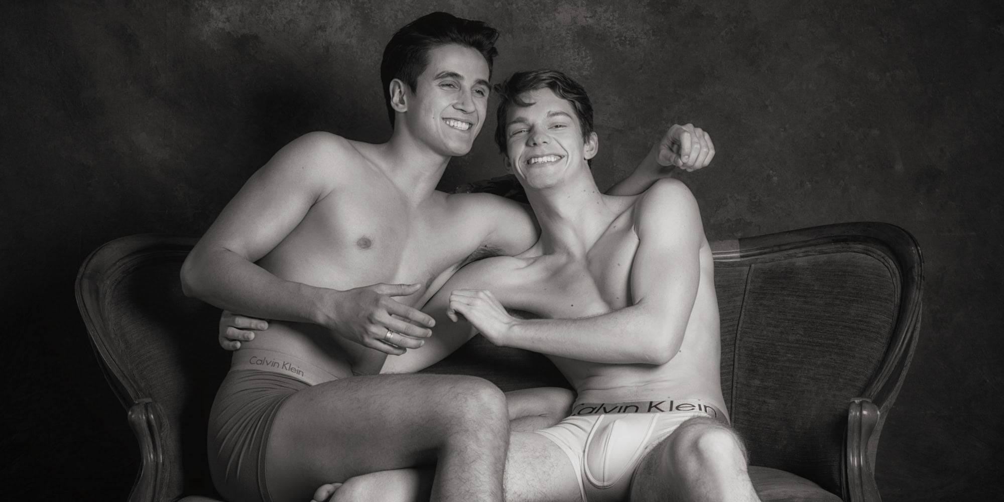Gay couples boudoir photography Houston — playful black and white session on settee by Trey Fox